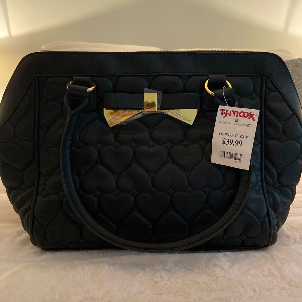 Medium/large-sized black Betsy Johnson purse.